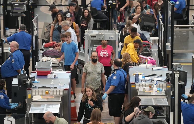 Travelers wade through long lines at the north security checkpoint in Denver International Airport Tuesday, July 5, 2022, in Denver. (AP Photo/David Zalubowski) CODZ114 CODZ114