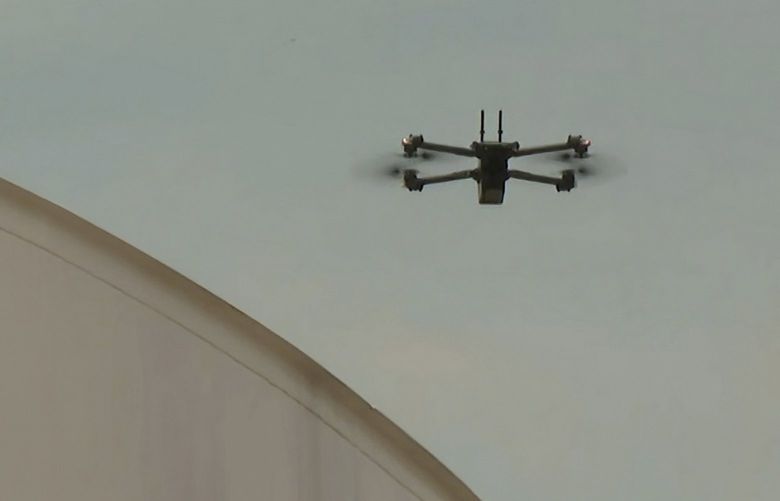 In this image from video, Dominion Energy drone operators fly a drone to inspect areas of a power plant in Remington, Va., on June 8, 2022. A small but growing group of drone pilots with power companies, railways and delivery services are getting permission to soar “beyond visual line of sight” with waivers from the Federal Aviation Administration. (AP Photo/Nathan Ellgren) 