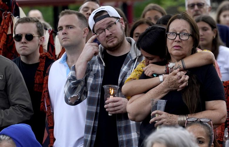 Residents from around the Highland Park, Ill., area listen during a vigil in Highwood, Ill., for the victims of Monday’s Highland Park Fourth of July parade mass shooting, Wednesday, July 6, 2022. (AP Photo/Charles Rex Arbogast) ILCA136 ILCA136