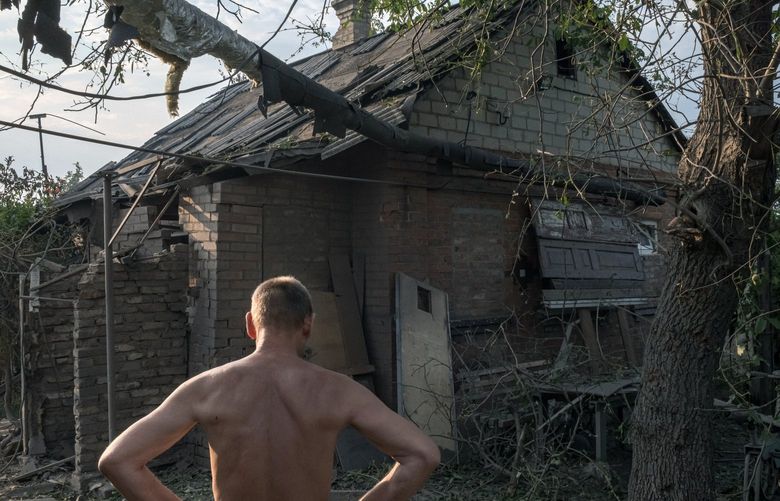 A man surveys the damage to his cousin’s home after a Russian shelling attack in Sloviansk, in eastern Ukraine, on Tuesday, July 5, 2022. More than 7.1 milllion people are estimated to be displaced inside Ukraine, posing a challenge that will loom long after the war.  (Mauricio Lima for The New York Times) XNYT136 XNYT136