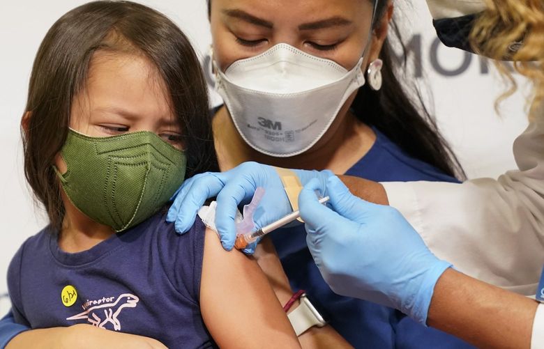 FILE – Maria Assisi holds her daughter Mia, 4, as registered nurse Margie Rodriguez administers the first dose of the Moderna COVID-19 vaccine for children 6 months through 5 years old, June 21, 2022, at Montefiore Medical Group in the Bronx borough of New York. Nearly 300,000 children under 5 have received a COVID-19 shot in the two weeks since they’ve been available, with the White House saying the slow pace of vaccinating the eligible population of about 18 million kids was expected. (AP Photo/Mary Altaffer, File) WX111 WX111