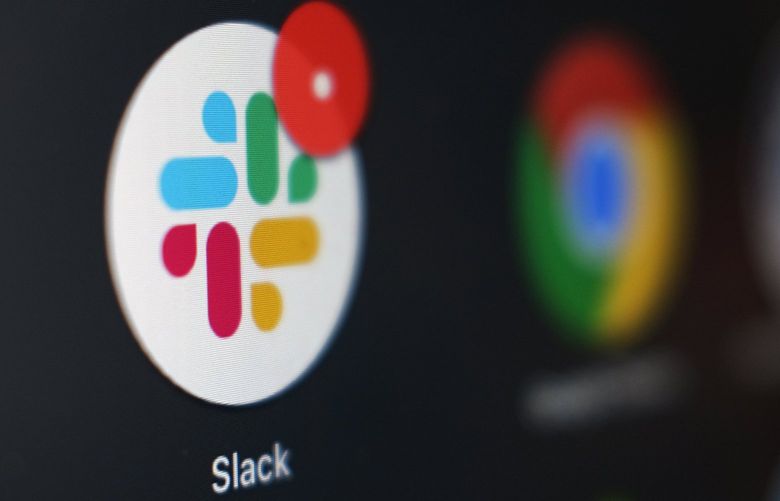 The Slack app icon being displayed on a computer screen in Tokyo in 2020. (AP Photo / Kiichiro Sato, File) 