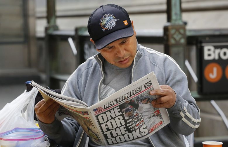A man reads the New York Post, Monday, May 7, 2018, in New York. (AP Photo/Mark Lennihan)