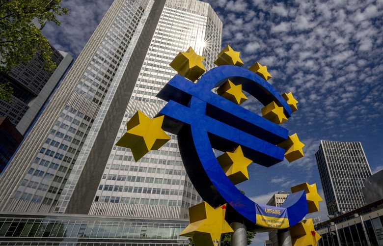 The Euro sculpture stands in front of the former European Central Bank in Frankfurt, Germany, Wednesday, July 13, 2022. The euro on Tuesday fell to parity with the dollar for the first time in nearly 20 years. (AP Photo/Michael Probst) PRO111 PRO111