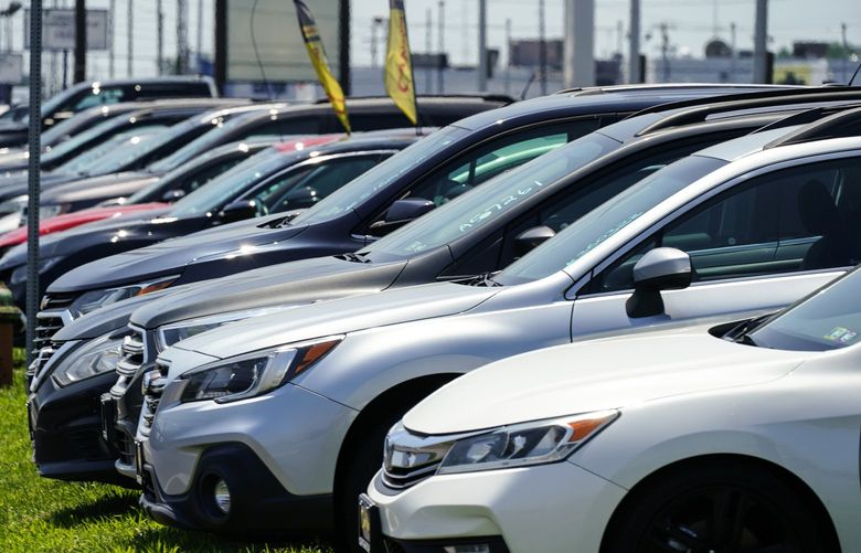 Used cars for sale are parked roadside at an auto lot in Philadelphia,  July 12, 2022. By raising borrowing rates, the Fed makes it costlier to take out a mortgage or an auto or business loan.(Matt Rourke / AP) 