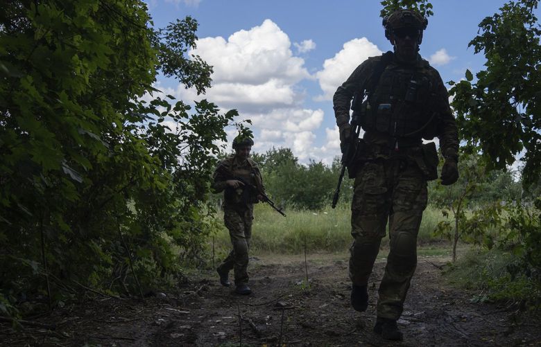Ukrainian servicemen of Khartia battalion patrol the area at the frontline near Kharkiv, Ukraine, on Tuesday, July 12, 2022. (AP Photo/Evgeniy Maloletka) XSG109 XSG109