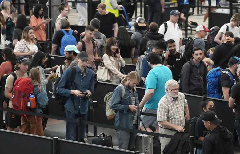 FILE – Travelers wait in long lines at a security checkpoint in Denver International Airport Tuesday, July 5, 2022, in Denver. The Fourth of July holiday weekend jammed U.S. airports with the biggest crowds since the pandemic began in 2020. (AP Photo/David Zalubowski) NY491 NY491