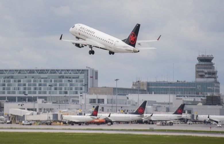 An Air Canada jet takes off from Trudeau Airport in Montreal, Thursday, June 30, 2022. Air Canada is cutting more than 15 per cent of its scheduled flights in July and August as airports face lengthy delays and cancellations amid an overwhelming travel resurgence.  (Graham Hughes /The Canadian Press via AP) 