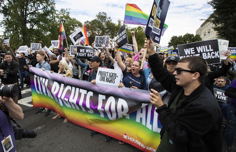 FILE – In this Oct. 8, 2019, photo, supporters of LGBTQ rights stage a protest on the street in front of the U.S. Supreme Court in Washington. A judge in Tennessee on Friday, July 15, 2022, has temporarily barred two federal agencies from enforcing directives issued by President Joe Biden’s administration that extended protections for LGBTQ people in schools and workplaces. (AP Photo/Manuel Balce Ceneta, File) NYPH300 NYPH300