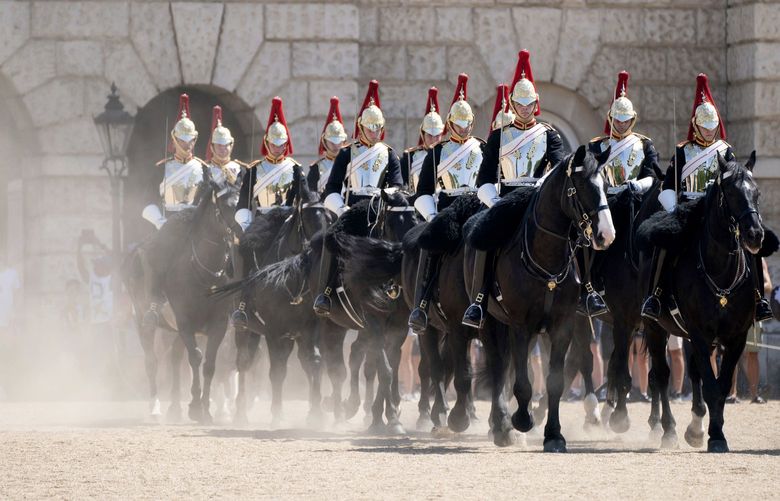 Members of the Household Cavalry kick up the dust as they ride across Horse Guards Parade, London, Tuesday July 19, 2022. Britain shattered its record for highest temperature ever registered Tuesday, with a provisional reading of 39.1 degrees Celsius (102.4 degrees Fahrenheit), according to the country’s weather office â€” and the heat was only expected to rise. (Dominic Lipinski/PA Wire/PA via AP) LBL815 LBL815