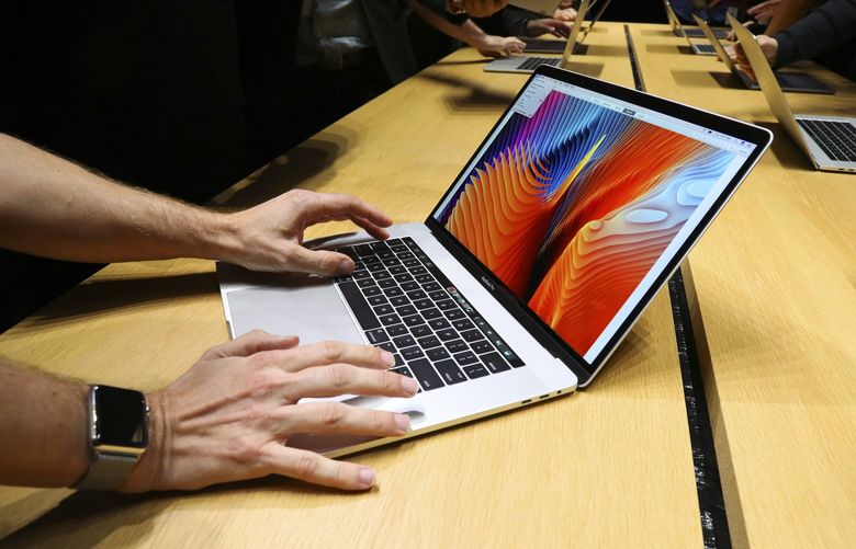 A MacBook Pro is displayed at Apple headquarters in Cupertino, Calif., in 2016. Apple agreed to a $50 million settlement on Monday for defective MacBook keyboards, in response to a class-action lawsuit. (Jim Wilson / The New York Times)