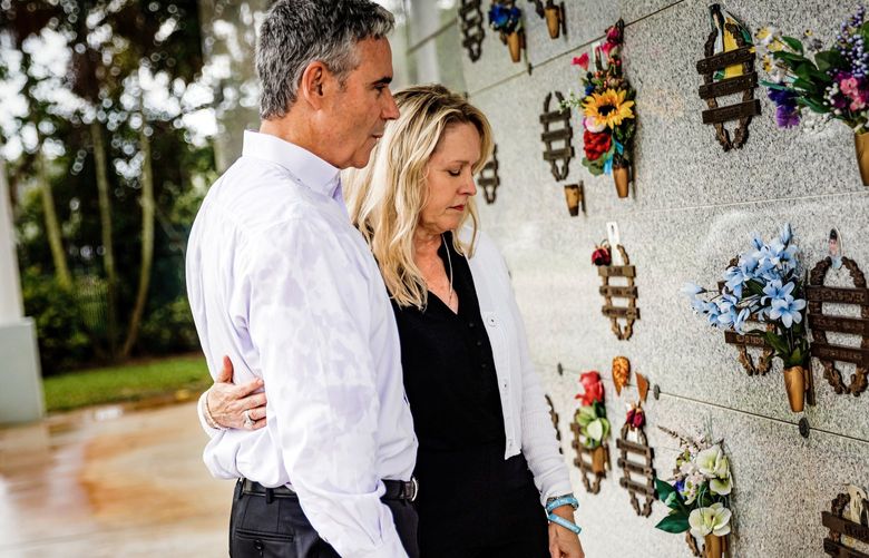 FILE – Tom and Gena Hoyer visit the gravesite of their son Luke, who was killed in the mass shooting at Marjory Stoneman Douglas High School, at a cemetery in Pompano Beach, Fla., May 23, 2022. Over four years later, as the perpetrator’s trial for sentencing continues, the couple has come to think of justice more broadly – not just as the punishment of an individual, but as their own power to try to make schools safer, and to rebuild their family. (Scott McIntyre/The New York Times) XNYT61 XNYT61