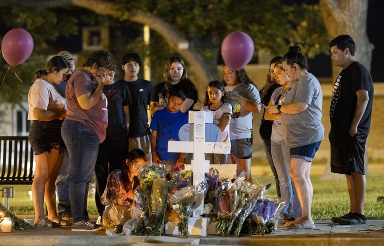 FILE — Family and relations of Alexandria Rubio, 10, gather at a makeshift memorial to the victim of the Robb Elementary mass shooting, in the town square of Uvalde, Texas, May 27, 2022. This month alone, California’s Gov. Gavin Newsom has signed into law more than 10 new firearm restrictions, including one that allows Californians to sue anyone who distributes banned assault weapons or ghost guns. (Ivan Pierre Aguirre/The New York Times)