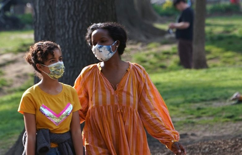 FILE – People wear masks in Fort Greene Park in New York, April 28, 2021. The surge of the Omicron subvariant BA.5 is a reminder that we need to take precautions to avoid illness, slow the relentless cycle of new variants and minimize the disruption to our daily lives. (Michelle V. Agins/The New York Times) XNYT123 XNYT123