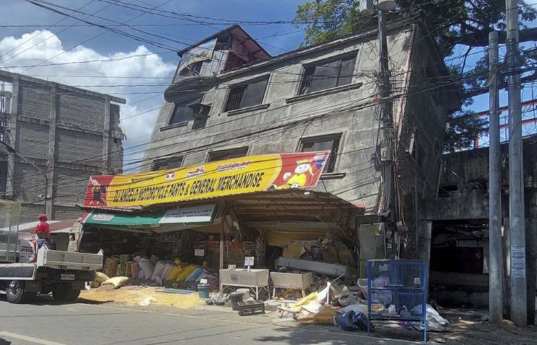 A damaged building lies on its side after a strong quake hit Bangued, Abra province, northern Philippines on Wednesday July 27, 2022. A strong earthquake shook the northern Philippines on Wednesday, causing some damage and prompting people to flee buildings in the capital. Officials said no casualties were immediately reported. (AP Photo) XAF107 XAF107