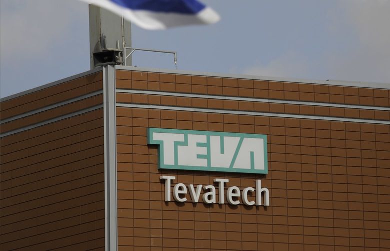 FILE – An Israeli flag flies outside a Teva Pharmaceutical Industries building on Dec. 14, 2017, in Neot Hovav, Israel. The company announced Tuesday, July 26, 2022, that it has agreed to contribute more than $4.3 billion in cash and medications to settle lawsuits in the state and local governments and Native American tribes that claimed the company contributed to the U.S. opioid epidemic. (AP Photo/Tsafrir Abayov, File) NYAB217 NYAB217