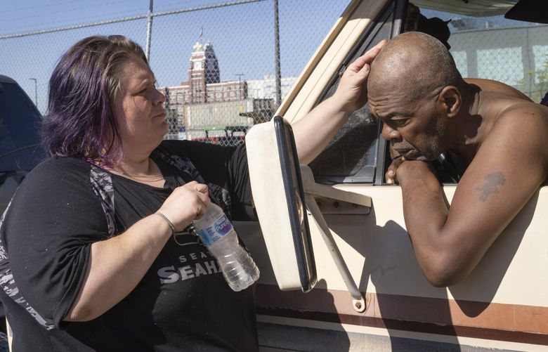 Crystal Rawlings gives her partner Rah Clarke some comfort before their vehicle is towed away by a friend during a sweep of the homeless camp where they live on 3rd Avenue South near South Holgate St. in Seattle  Tuesday, July 26, 2022. Clarke said they have lived there for about a year.

The City of Seattle is clearing a large homeless encampment in SODO with  around 30 vehicles and an unknown number of tents.  After residents took their belongings and rv’s that didn’t run were towed away, what remained was picked up and carried away. 221075