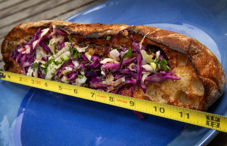 The sandwiches at Bucatini Italian restaurant in Edmonds are a foot long and can feed two. Picture is the rockfish sub stuffed with filets and a citrusy remoulade and slaw, Saturday, July 23, 2022 in Seattle.