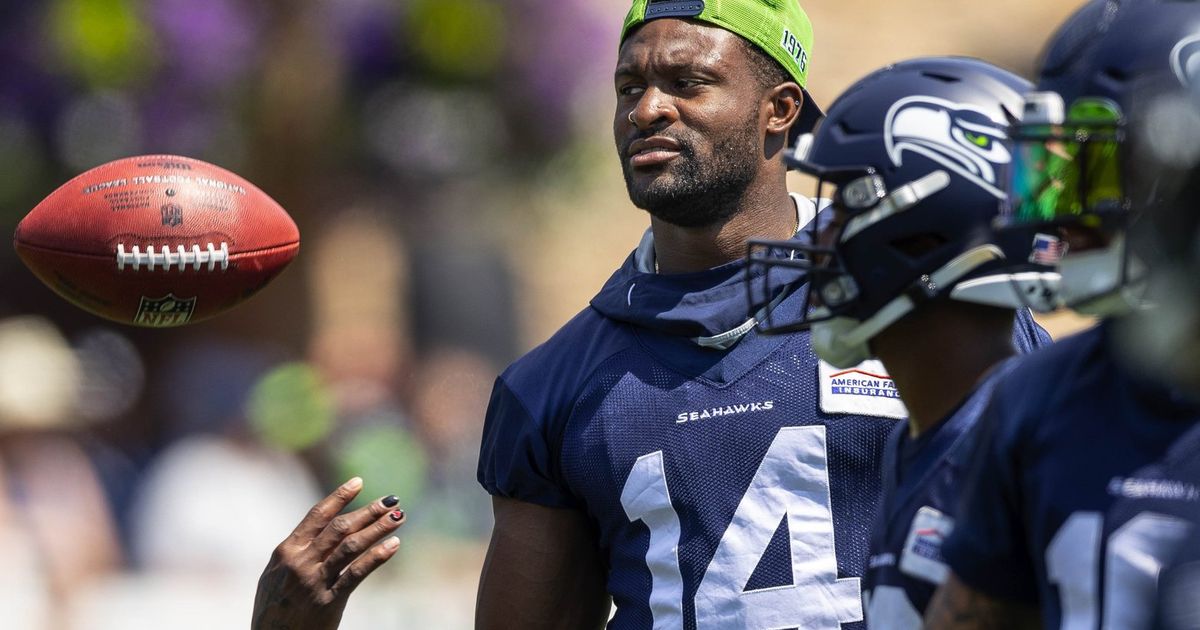 Larry Wales, of Seattle, wears the #14 jersey of Seattle Seahawks wide  receiver DK Metcalf as well as Metcalf's trademark pacifier mouth guard as  he arrives to watch NFL football practice, Wednesday