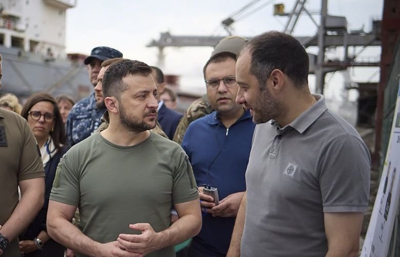 In this photo provided by the Ukrainian Presidential Press Office, Ukrainian President Volodymyr Zelenskyy, center, surrounded by ambassadors of different countries and UN officials, visits a port in Chornomork during loading of grain on a Turkish ship, background, close to Odesa, Ukraine, Friday, July 29, 2022. (Ukrainian Presidential Press Office via AP) XEL103 XEL103