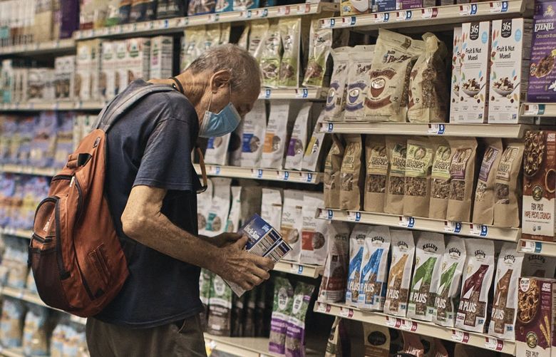 A man shops at a supermarket on Wednesday, July 27, 2022, in New York. The U.S. economy shrank from April through June for a second straight quarter, contracting at a 0.9% annual pace and raising fears that the nation may be approaching a recession.    (AP Photo/Andres Kudacki) NYBZ408 NYBZ408