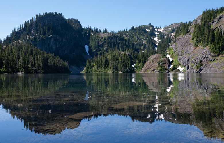 Rachel Lake’s calm, still waters beckon for a swim on a hot summer day in the Okanogan-Wenatchee National Forest and the Alpine Lakes Wilderness on July 24, 2022.
