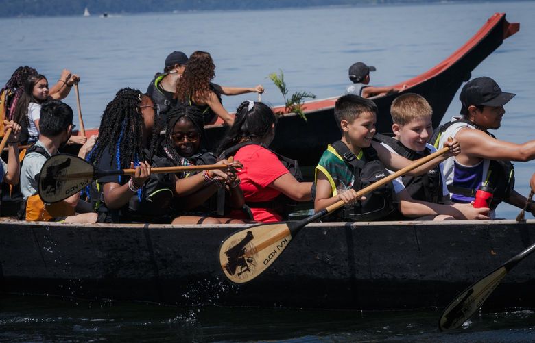 Students laugh and paddle during a trip out onto Elliott Bay for Enumclaw School District, Pierce College and Muckleshoot Cultural Center students on July 27, 2022.