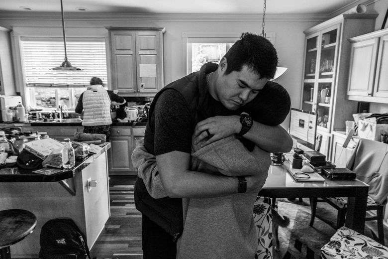My brother hugs a family friend after sharing the gospel with her. (Daniel Kim / The Seattle Times)