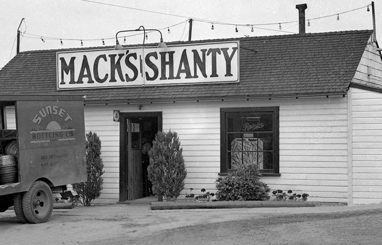 THEN2: Sunset Bottling Co. delivers beer to Mack’s Shanty Tavern in 1941. Note the truck’s cable-operated turn-signal arm. Credit: Puget Sound Regional Branch; Washington State Archives