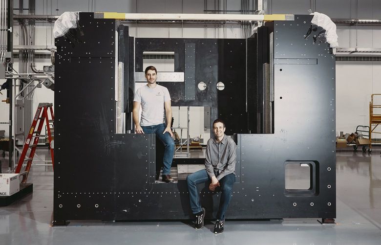 The frame of a 3D printer being built at VulcanForms, which was founded by Martin Feldmann, left, and John Hart, in Devens, Mass. on June 2, 2022. With the technology improving and costs falling, 3D printing could be poised to play a major role in manufacturing. (Simon Simard/The New York Times) XNYT36 XNYT36