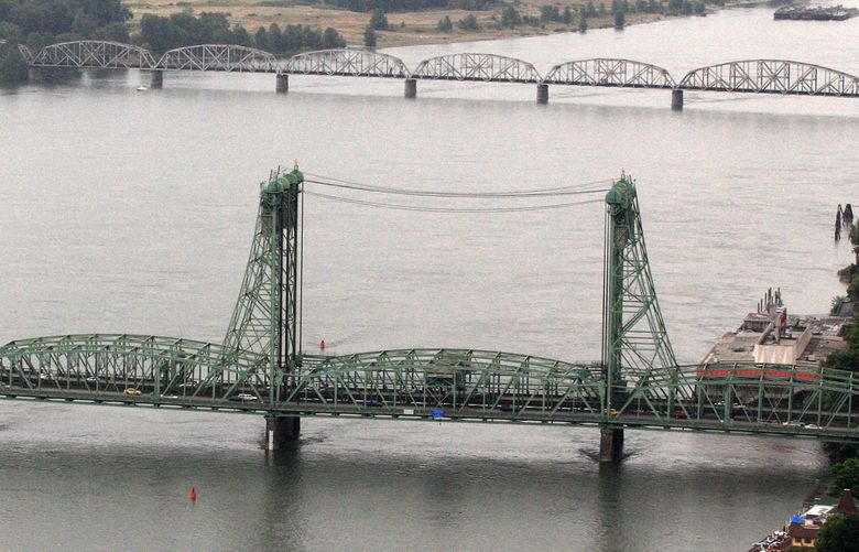 This June 29, 2012, photo shows the Interstate 5 bridge spanning the Columbia River between Oregon and Washington states, near Vancouver, Wash. Columbia River Crossing planners have been sued over the proposed 95-foot height of a new Interstate 5 bridge between Vancouver and Portland. (AP Photo/Rick Bowmer)