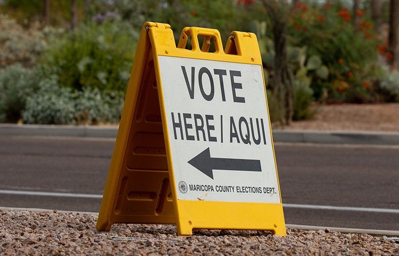 A “vote here” sign directs voters outside Marquee Theatre on Nov. 3, 2020, in Tempe, Arizona. (Courtney Pedroza/Getty Images/TNS) 53990183W 53990183W