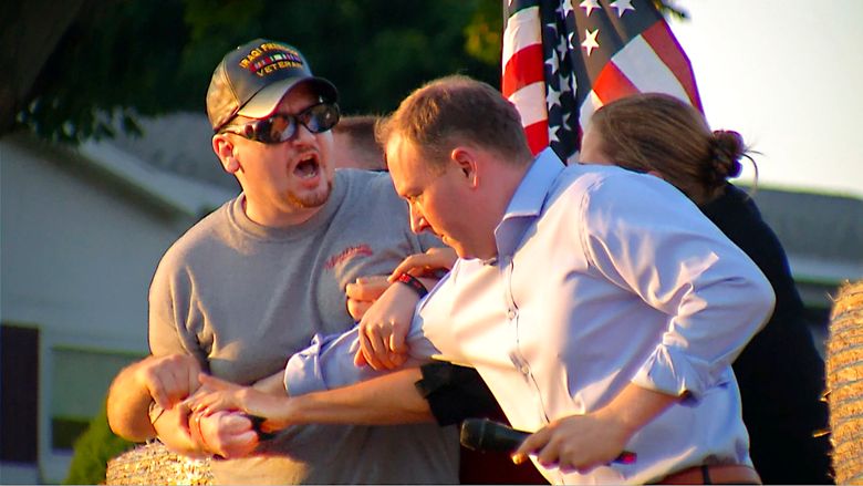 In this image taken from video provided by WHEC-TV, David Jakubonis, left, is subdued as he brandishes a sharp object during an attack U.S. Rep. Lee Zeldin, right, as the Republican candidate for New York governor delivered a speech in Perinton, N.Y., Thursday, July 21, 2022. Jakubonis, 43, has been charged with attempted assault, arraigned and released, a Monroe County sheriff’s spokesperson said. (WHEC-TV via AP)