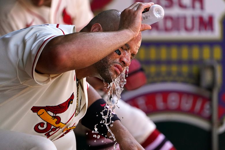 Miles Mikolas of the St. Louis Cardinals splashes water on his