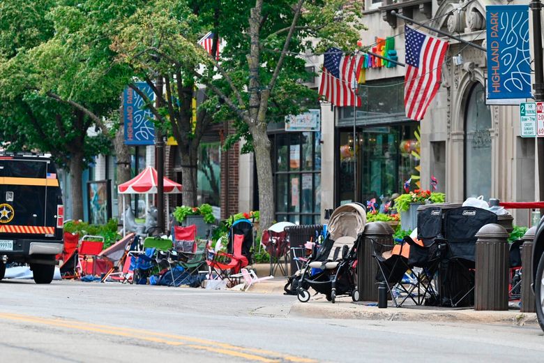 Empty chairs sit along the sidewalk after parade-goers fled Highland Park’s Fourth of July parade after shots were fired, Monday, July 4, 2022 in Chicago. (Tyler Pasciak LaRiviere/Chicago Sun-Times via AP)
