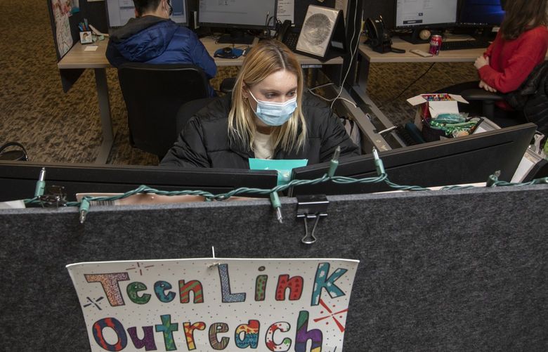 At the Crisis Connections offices, 17-year-old Laney Brackett helps another teen via text messaging through the Teen Link hotline, where young people navigate crisis and mental health concerns, Wednesday, Feb. 2, 2022 in Renton. 219480
