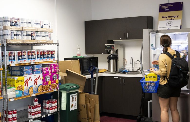 A student shops at the Any Hungry Husky campus food pantry at the University of Washington in Seattle Thursday May 9, 2019. The pantry previously had been operating for the last few years as a pop-up on campus, but demand was so high that wait times were long. Their new location at Poplar Hall has been open since November 2018. It is open to students, staff, and faculty of the college and accessible with a UW Husky ID Tuesdays through Fridays. 210224