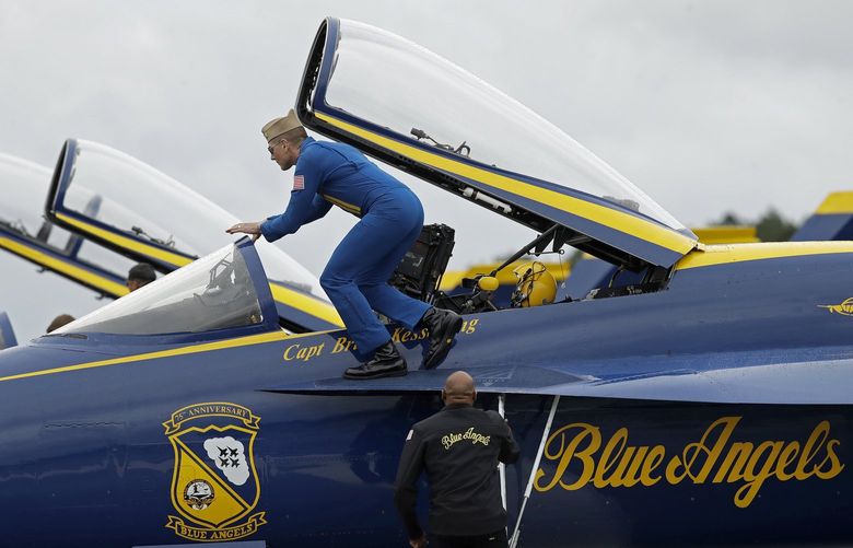 U. S. Navy Capt. Brian Kesserling, Blue Angel flight leader, climbs into an F/A-18E Super Hornet jet, Friday, Oct. 29, 2021, in Rome, Ga. Practice for all but one of the Angels was canceled this afternoon due to rain. This weekend, the Blue Angels will fly in two air shows as part of the Wings Over North Georgia Air Show. (AP Photo/Ben Margot)