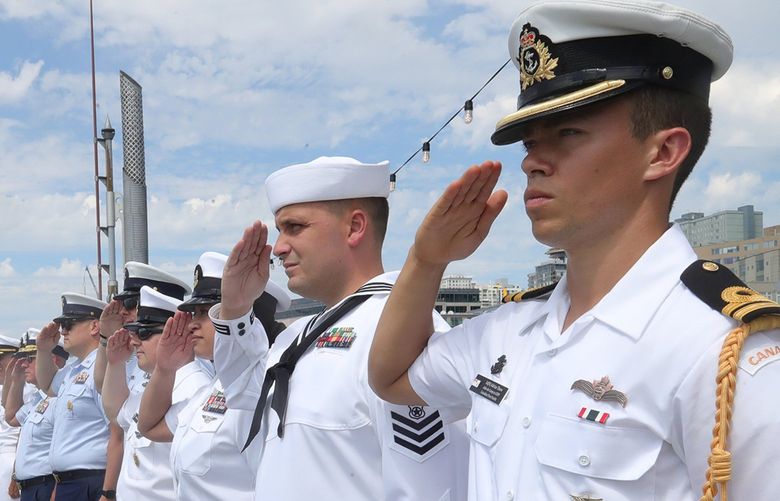 Navy officers salute ships from the U.S. Navy, U.S. Coast Guard, and Royal Canadian Navy and Coast Guard rescue helicopter. in a SeaFair Fleet Week parade in Elliott Bay, Monday, August 1, 2022. At far right is Canadian Fleet Pacific Navy officer Lt Adrian ’thow.
LO LO LO 221142