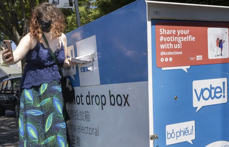 Anne Stewart takes a selfie as she drops her ballot into the ballot drop box near the intersection of 6th Ave. S. And S. Dearborn St. in Seattle Tuesday, August 2, 2022.  Tuesday is Primary Election Day in Washington state and the turnout is expected to be low. 221161