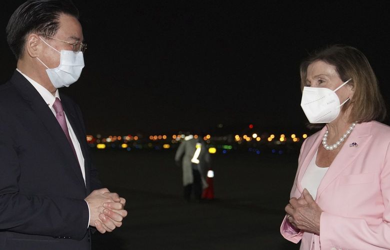 In this photo released by the Taiwan Ministry of Foreign Affairs, U.S. House Speaker Nancy Pelosi, right is greeted by Taiwan’s Foreign Minister Joseph Wu as she arrives in Taipei, Taiwan, Tuesday, Aug. 2, 2022. Pelosi arrived in Taiwan on Tuesday night despite threats from Beijing of serious consequences, becoming the highest-ranking American official to visit the self-ruled island claimed by China in 25 years. ( Taiwan Ministry of Foreign Affairs via AP) XHG401 XHG401