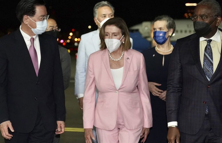 In this photo released by the Taiwan Ministry of Foreign Affairs, U.S. House Speaker Nancy Pelosi, center, arrives in Taipei, Taiwan, Tuesday, Aug. 2, 2022. Pelosi arrived in Taiwan on Tuesday night despite threats from Beijing of serious consequences, becoming the highest-ranking American official to visit the self-ruled island claimed by China in 25 years. ( Taiwan Ministry of Foreign Affairs via AP) XHG403 XHG403