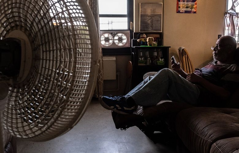 Rafael Velasquez, 66, sits near a fan in his apartment in Brooklyn on Saturday, July 23, 2022. Fans can help circulate the air but don’t always help when the humidity is high. (Juan Arredondo/The New York Times) XNYT86 XNYT86