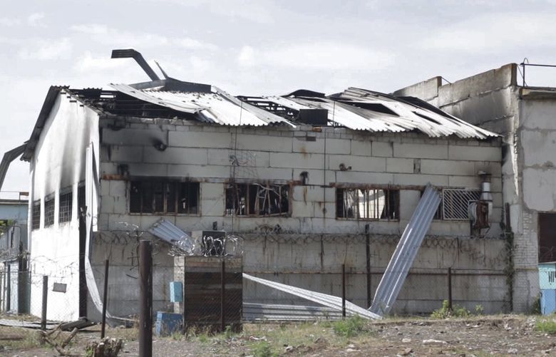 FILE – In this photo taken from video a view of a destroyed barrack at a prison in Olenivka, in an area controlled by Russian-backed separatist forces, eastern Ukraine, on July 29, 2022. Russia and Ukraine accused each other Friday of shelling a prison in a separatist region of eastern Ukraine, an attack that reportedly killed dozens of Ukrainian military prisoners who were captured after the fall of a southern port city of Mariupol in May. (AP Photo) ALP106 ALP106