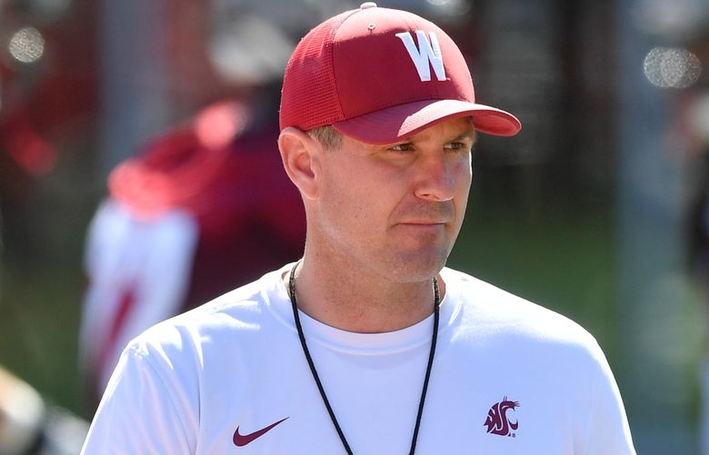 Washington State Cougars head coach Jake Dickert watches his team during a college football practice on Wednesday, Aug. 3, 2022, at WSU’s practice facility in Pullman, Wash.
