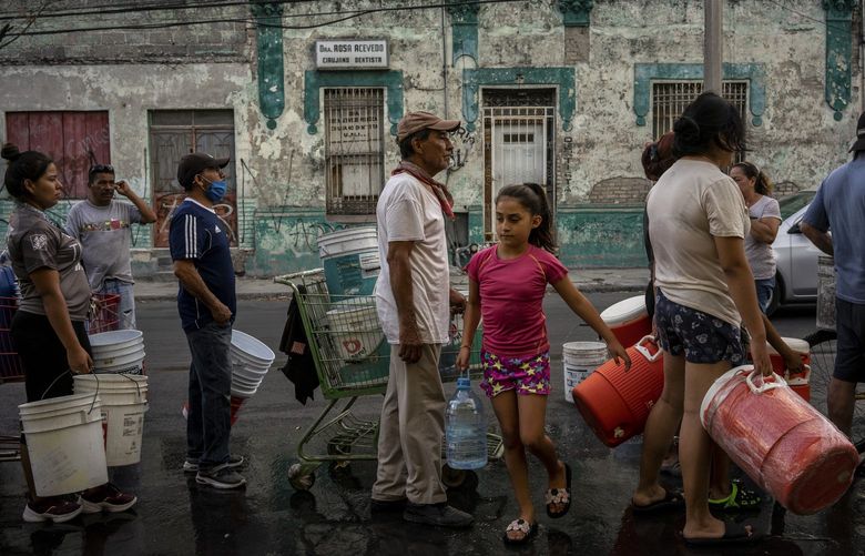 Residents line up to fill their containers with water in Monterrey, the second largest city in Mexico, on June 21, 2022. Nearly two-thirds of the country’s municipalities are facing a water shortage; and in Monterrey, a major economic hub, the government delivers water daily to 400 neighborhoods. (Cesar Rodriguez/The New York Times)