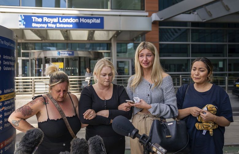 Hollie Dance, second left, surrounded by family and friends, outside the Royal London hospital addresses the media following the death of her 12 year old son Archie Battersbee, in Whitechapel, east London, Saturday, Aug. 6, 2022.  Archieâ€™s care became the subject of weeks of legal arguments as his parents sought to force the hospital to continue life-sustaining treatments and doctors argued there was no chance of recovery and he should be allowed to die. (Aaron Chown/PA via AP) AMB808 AMB808