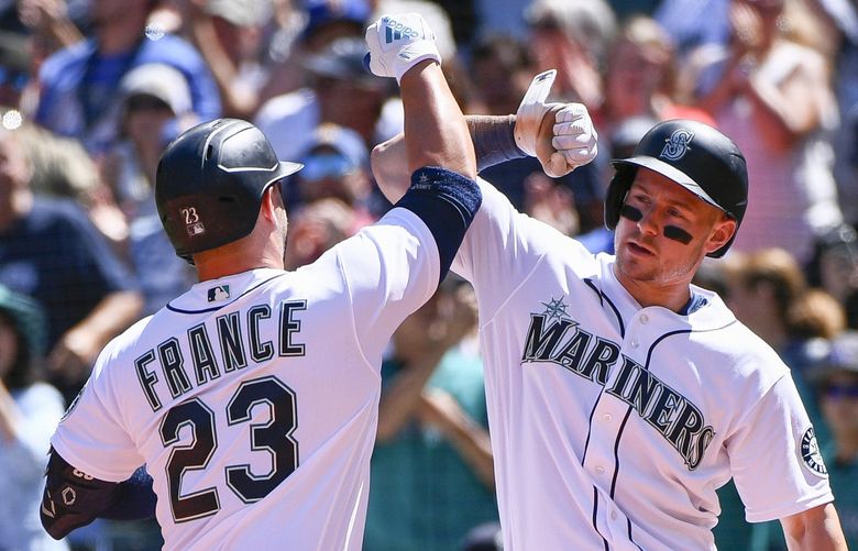 Seattle Mariners’ Ty France (23) celebrates at the plate with Jarred Kelenic after hitting a two-run home run during the third inning of a baseball game against the Los Angeles Angels, Saturday, Aug. 6, 2022, in Seattle. (AP Photo/Caean Couto) WACC104 WACC104