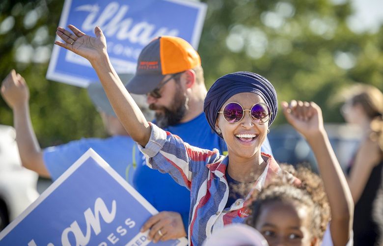 U.S. Rep. Ilhan Omar waves to passersby for support during a voter engagement event on the corner of Broadway and Central Avenues in Minneapolis, on Tuesday, Aug. 9, 2022. Omar faces a primary challenge from former city council member Don Samuels. (Elizabeth Flores/Star Tribune via AP) MNMIT222