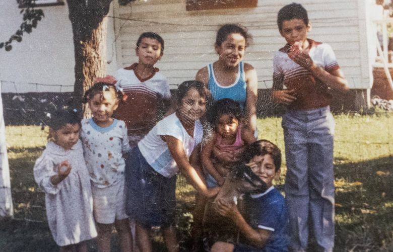 Picture of Luz Maria Iniguez (l) with her siblings and cousins when they were young and living in Yakima.   Iniguez grew up in an immigrant farm working family in Yakima, WA. Her family is one of six that had their early lives documented in the art exhibition “All the Sacrifices You’ve Made,” which will be on display at the Washington State History Museum in Tacoma, WA until October 16, 2022.
 221169